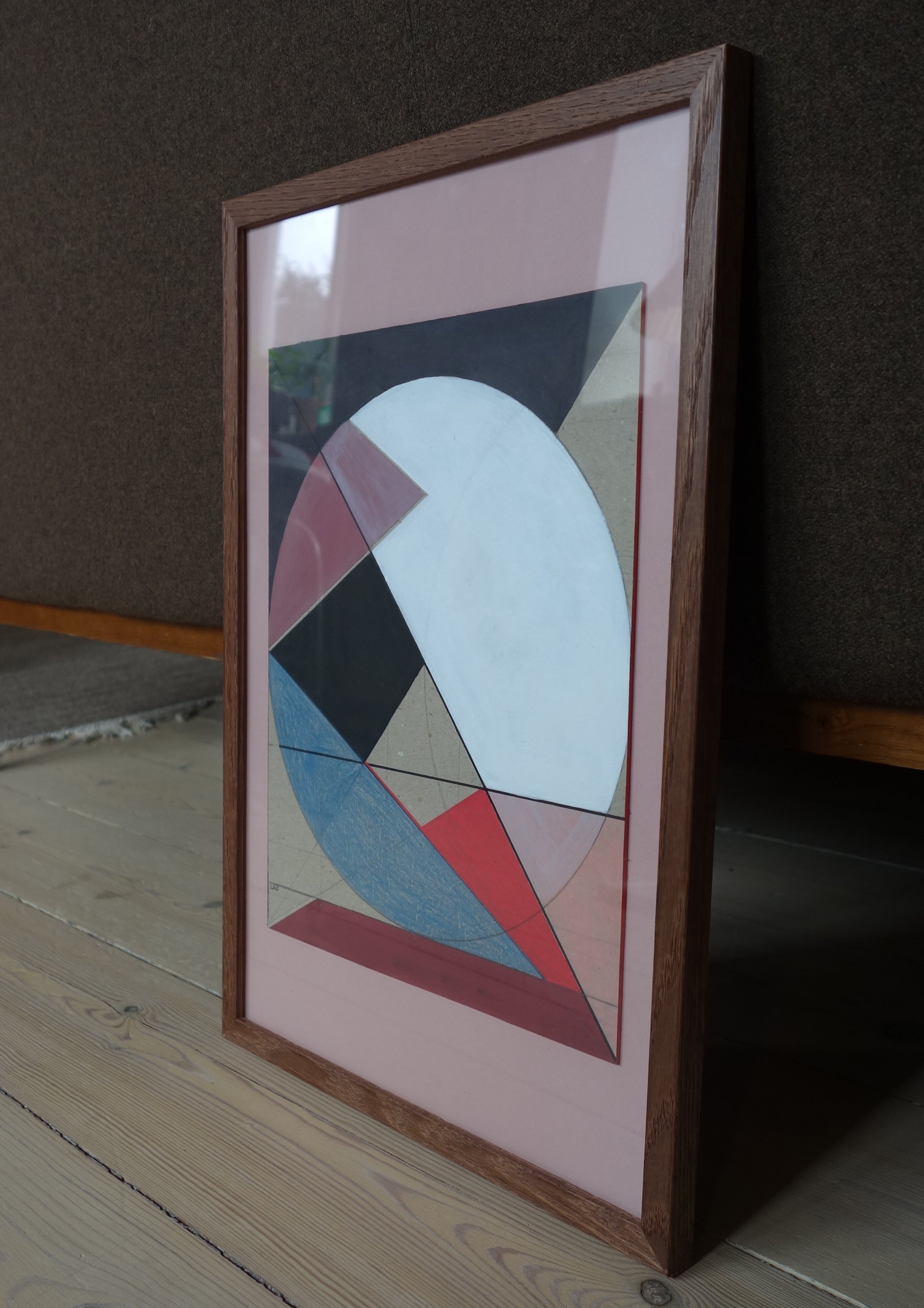 Geometric cardboard wall art composition in black frame