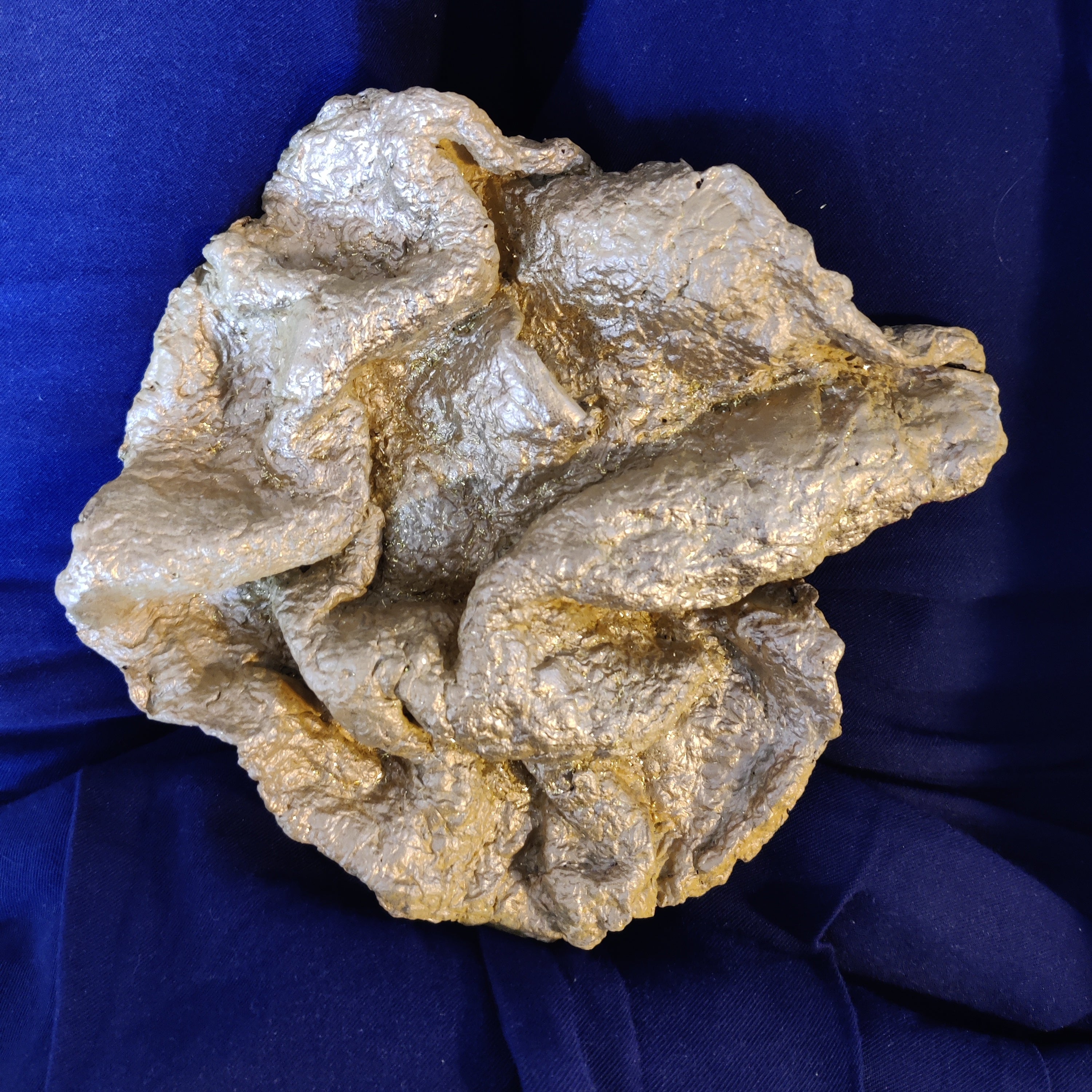 Golden paper pulp wallart, a compact relief that could be built from layered paper pulp like refined paper mache